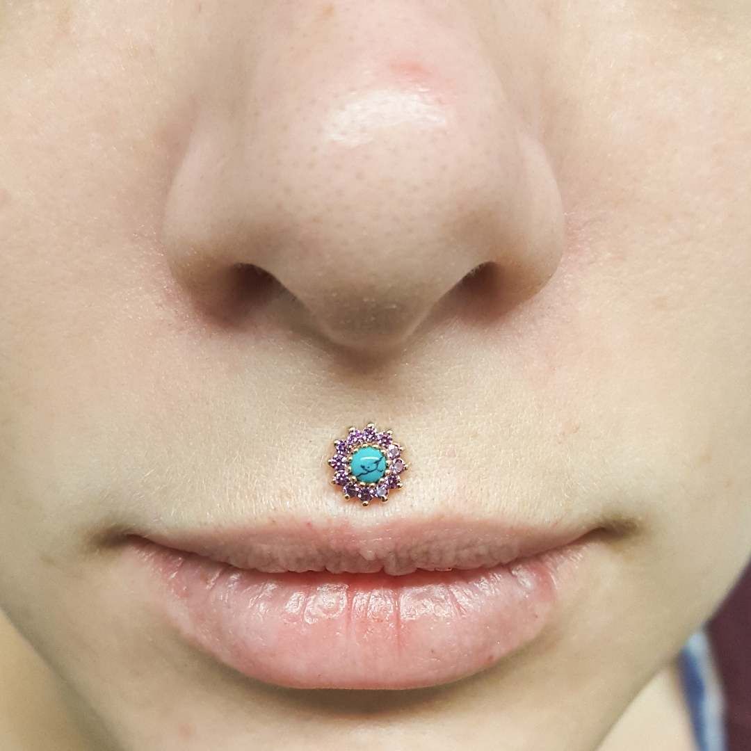 The Medusa piercing, also known as a philtrum piercing, has gained popularity for its striking appearance and unique pla