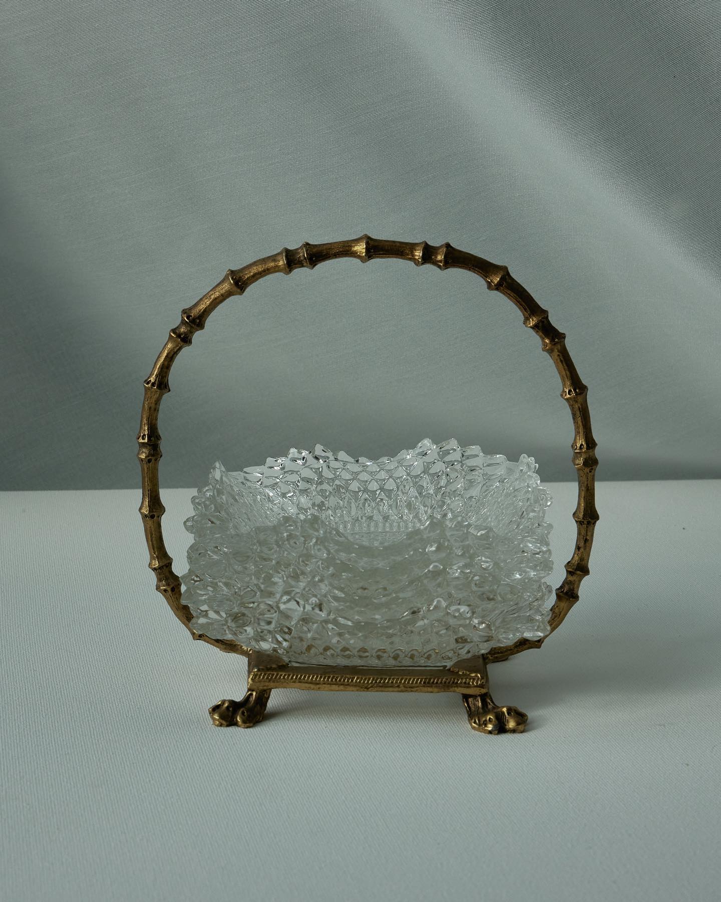 Unique gold metal vintage basket with 4 diamond point square ruffled, clear crystal glass dishes.

The bowls measure 4” 