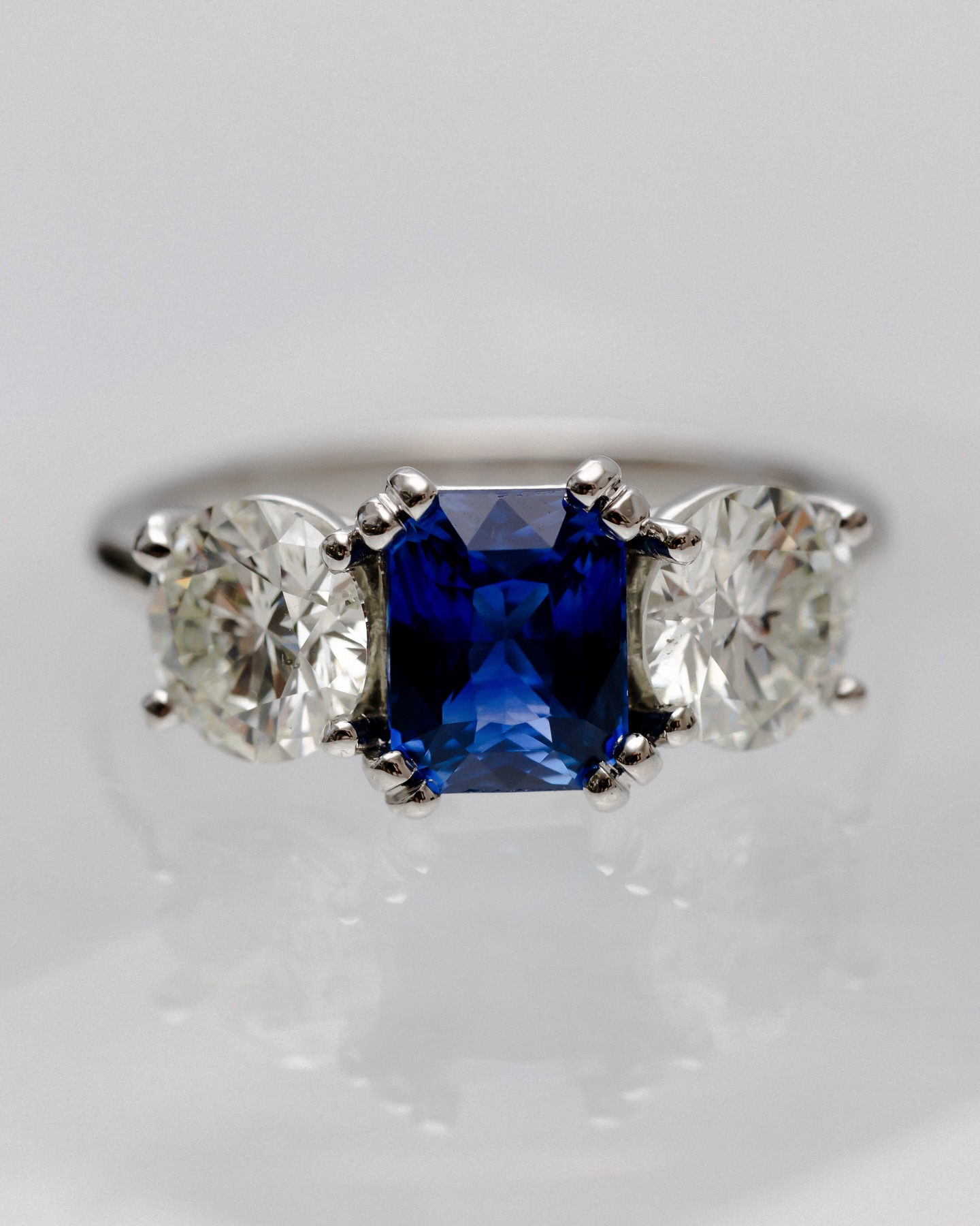 A sapphire design story: Our clients came to us with a pair of diamond studs that they envisioned setting in a three-sto