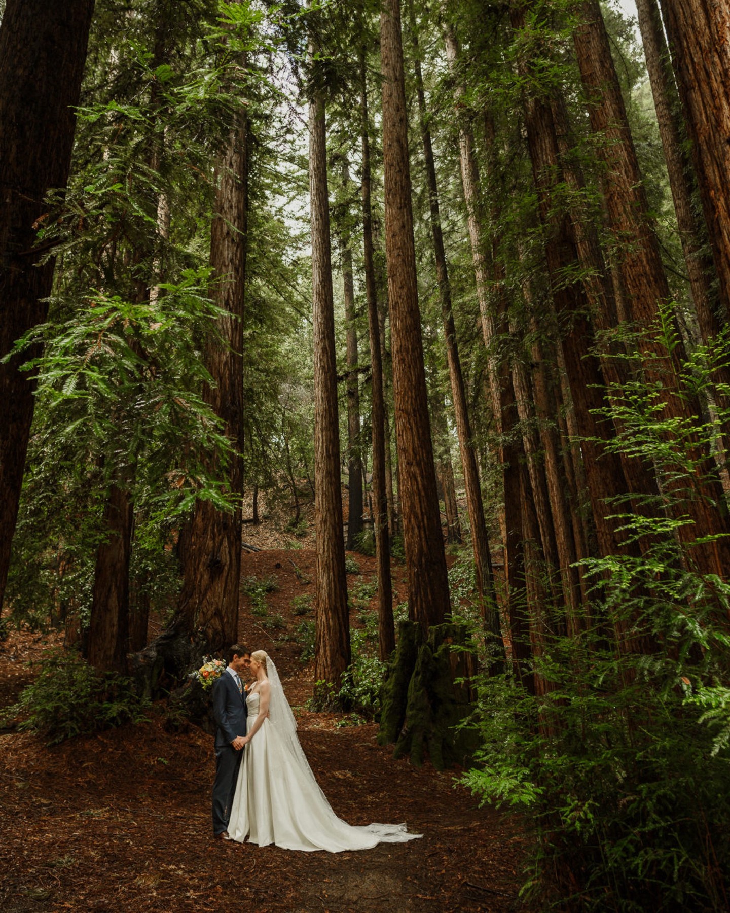 Despite a very wet start to their day, the rainclouds cleared just in time for K + M's vows in the misty, magical forest