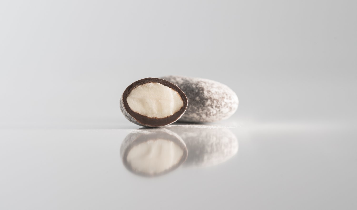 Almonds Caramelized in Dark Chocolate, powdered sugar — Jean-Marie Auboine Chocolatier thumbnail