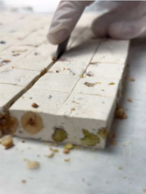 Ever wonder how our Honey 🍯 Nougat is made? Watch as we whip egg whites, prepare the syrup, blend golden honey, roast th
