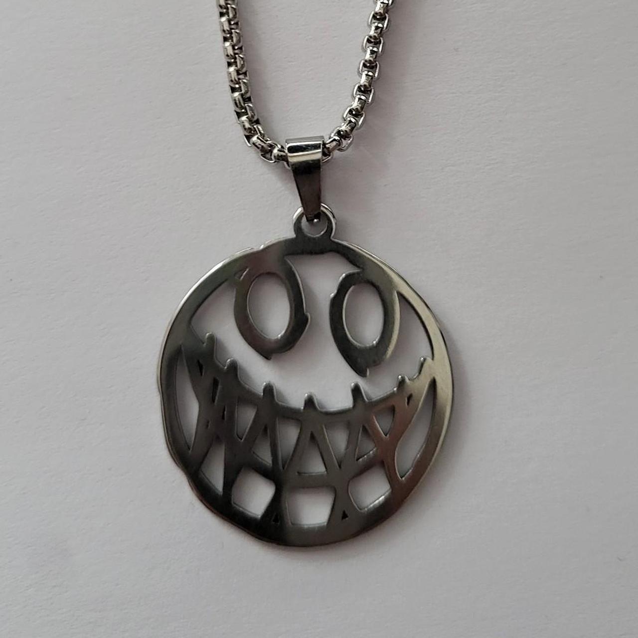 Silver scary smiley face emoji pendant | Depop thumbnail