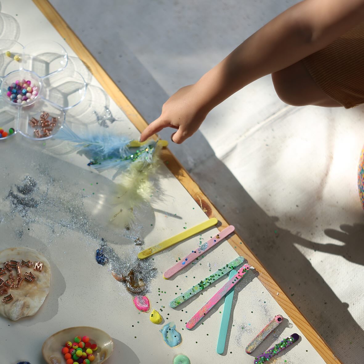 Images from our dazzling jewelry-making workshop, full of sparkling gems, vibrant beads, and lots of other colourful mat